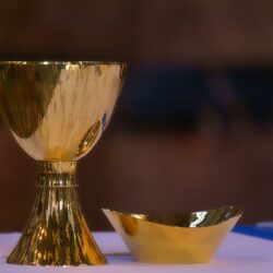 Gold chalice and salver on table