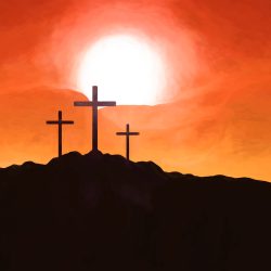 Three crosses on hill at sunset